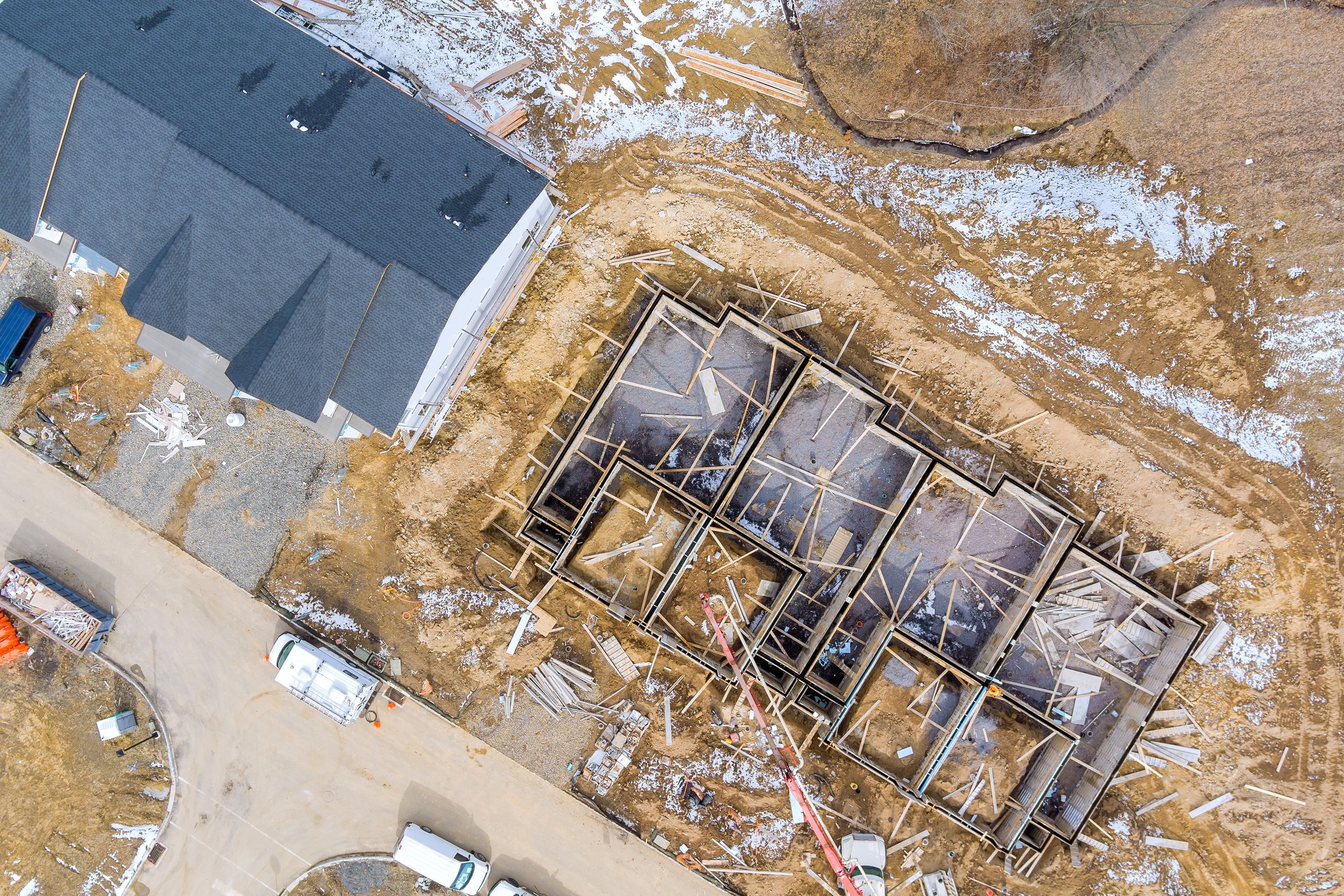 Aerial view on the preparation of the work for unfinished with foundation to new house construction