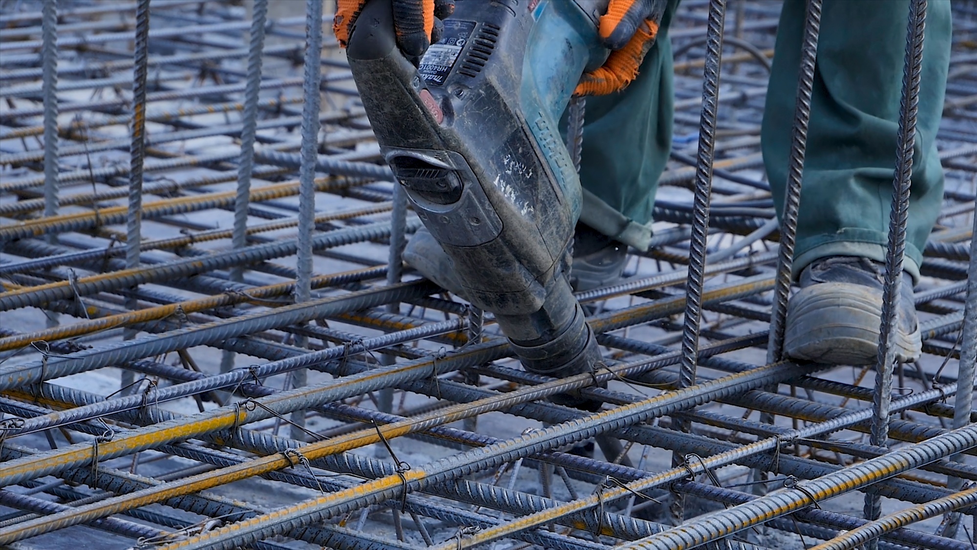 Construction worker. Worker in the construction site making reinforcement metal framework for