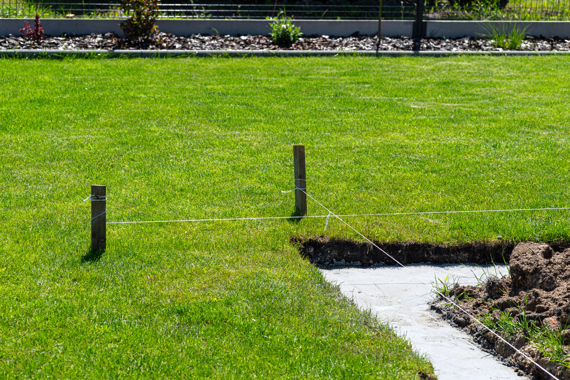 Foundation footings poured in a ditch in the yard, building a terrace in the backyard.