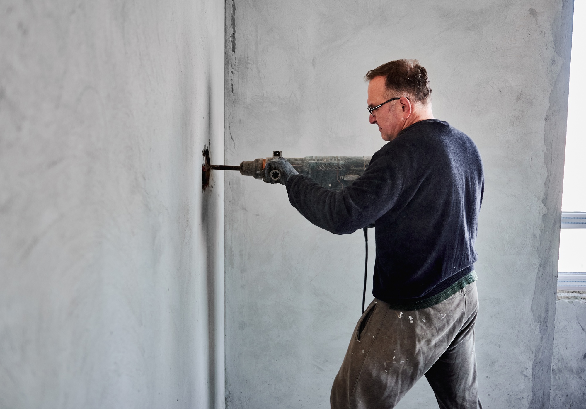 Repair work in the room using perforator.