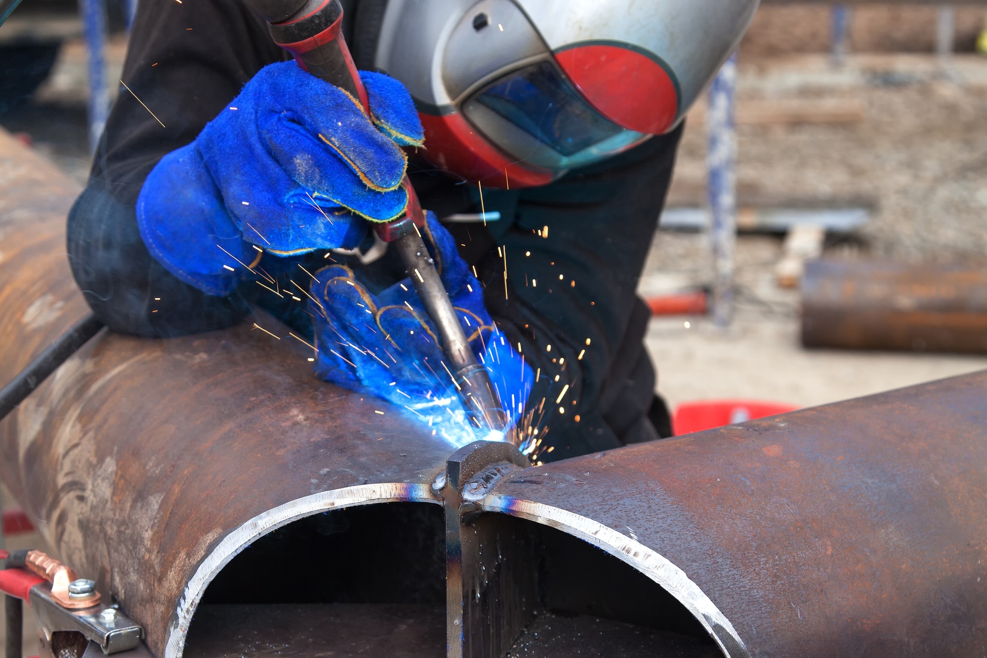 Welding work, welder welding metal material in heavy industry manufacturing